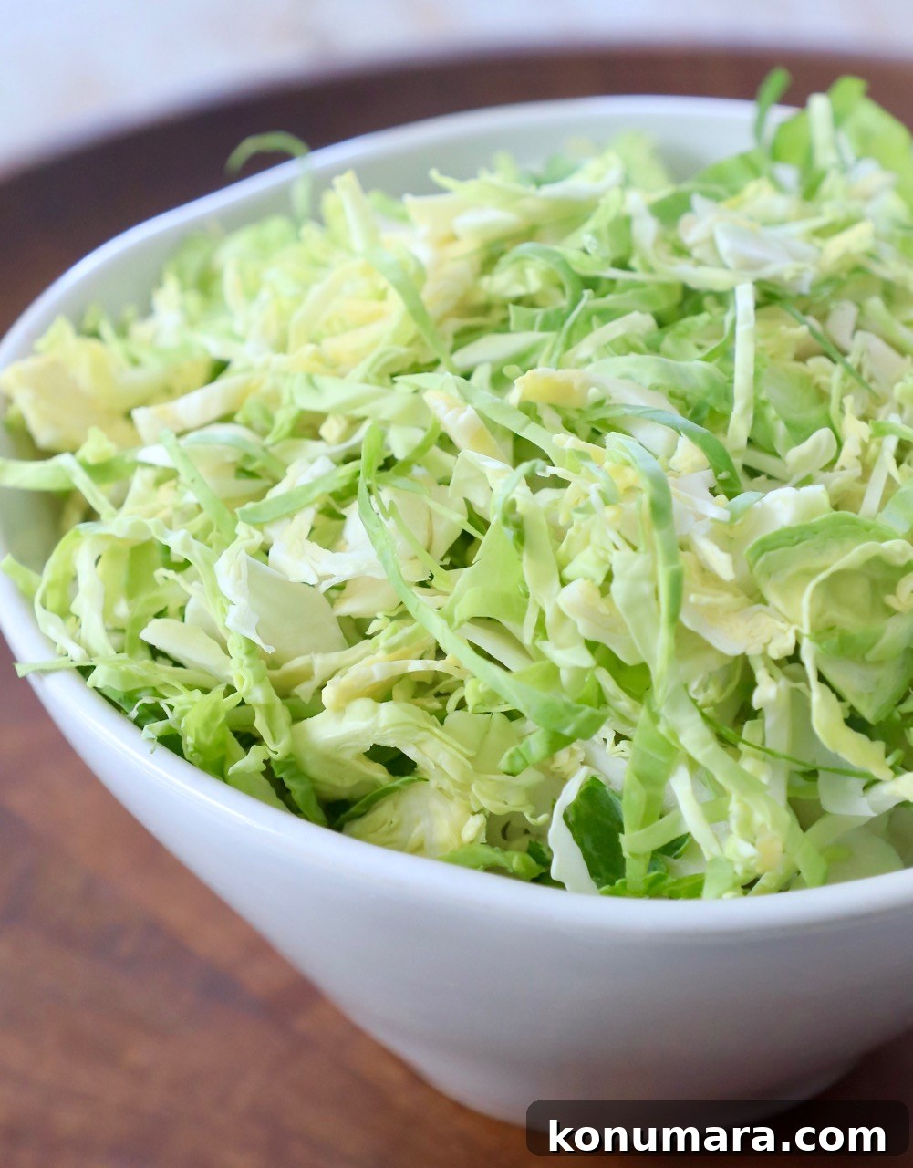 How to Shred Brussels Sprouts for Salads and Slaws 12 shredded brussels sprouts in white bowl