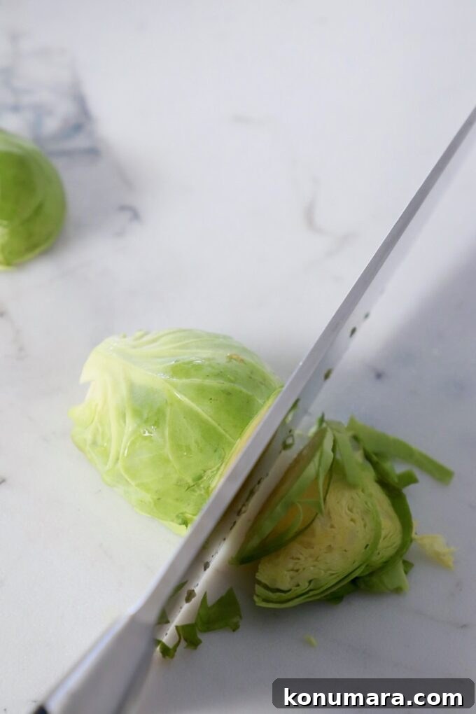 How to Shred Brussels Sprouts for Salads and Slaws 6 knife shredding brussel sprout on cutting board