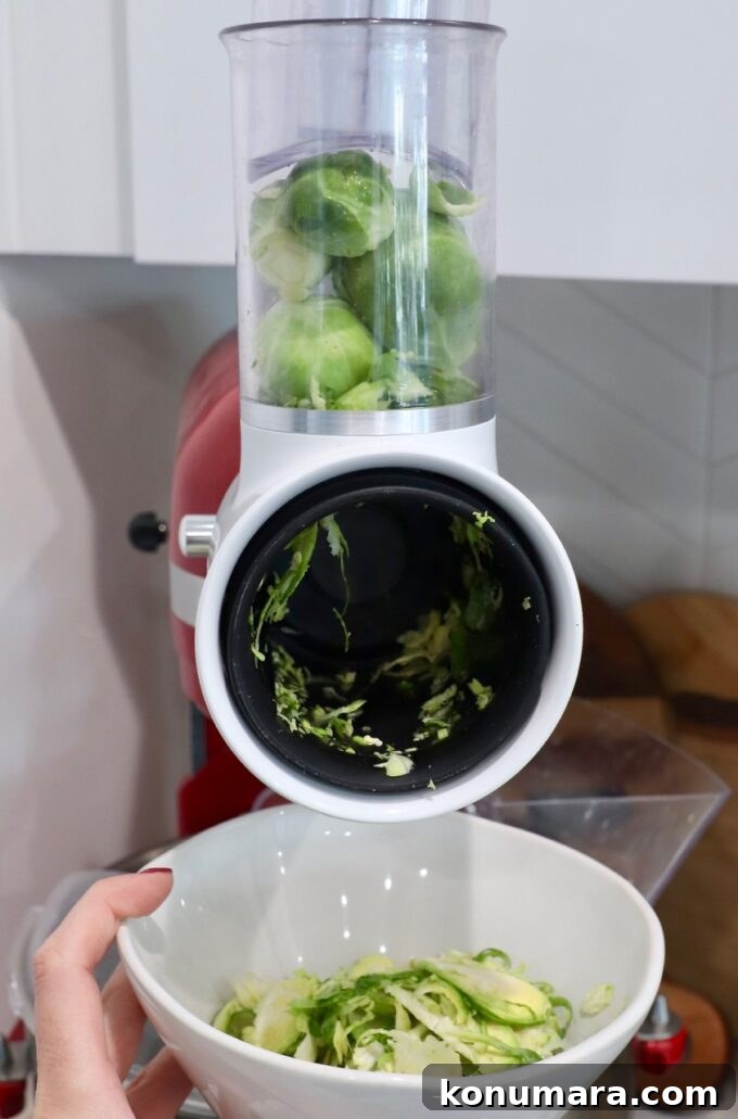 How to Shred Brussels Sprouts for Salads and Slaws 9 brussels sprouts in grater attachment on kitchenaid