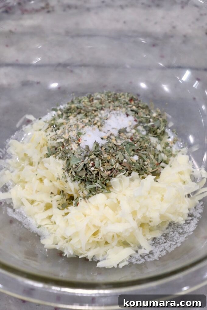 shredded cheese, herbs and butter in glass bowl