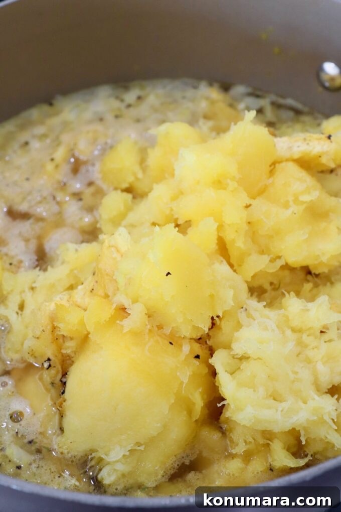 Creamy Roasted Acorn Squash Soup Recipe 6 roasted squash in pot with vegetables and broth