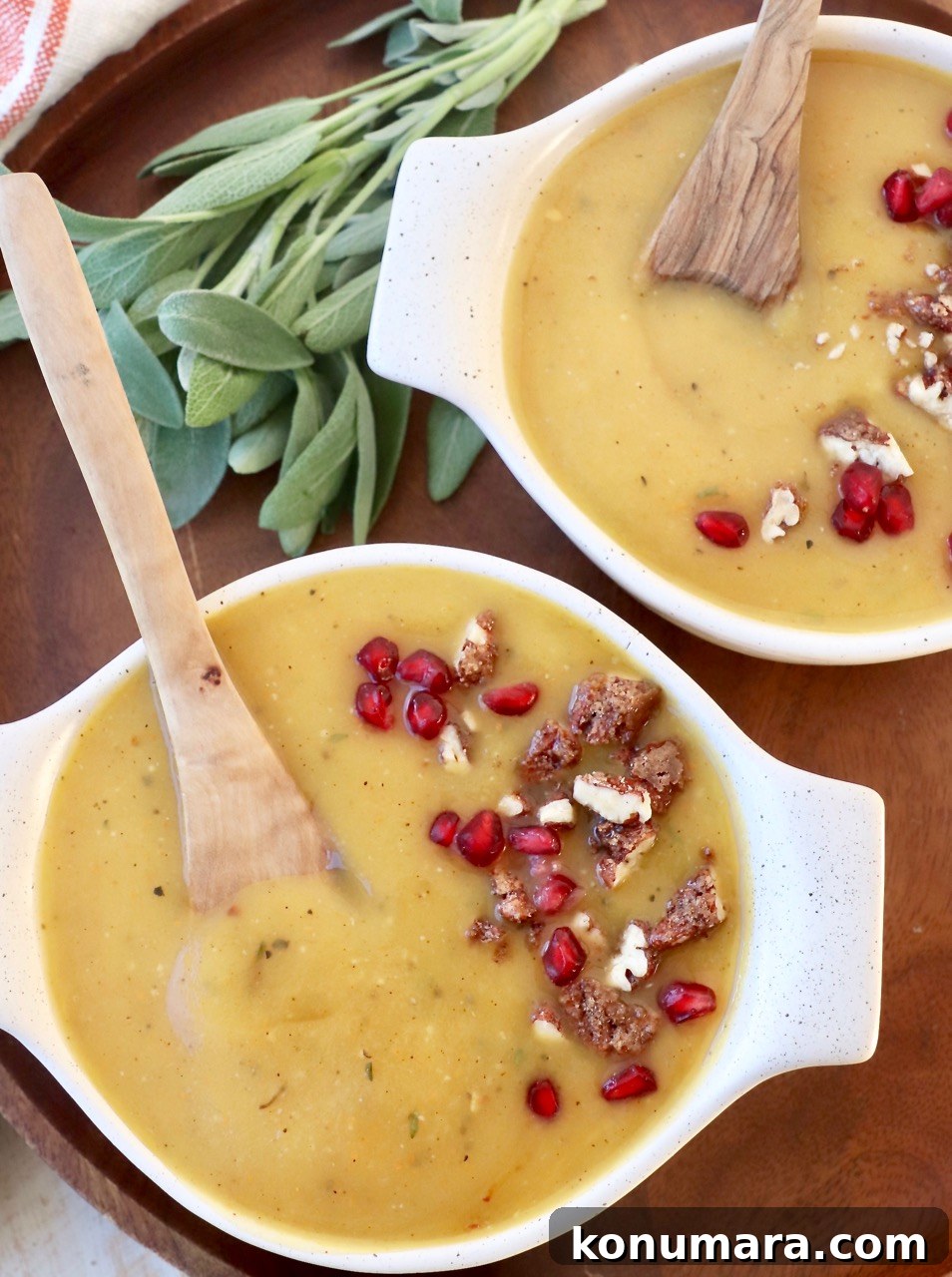Creamy Roasted Acorn Squash Soup Recipe 8 acorn squash soup in two bowls with spoons topped with walnuts and pomegranate seeds