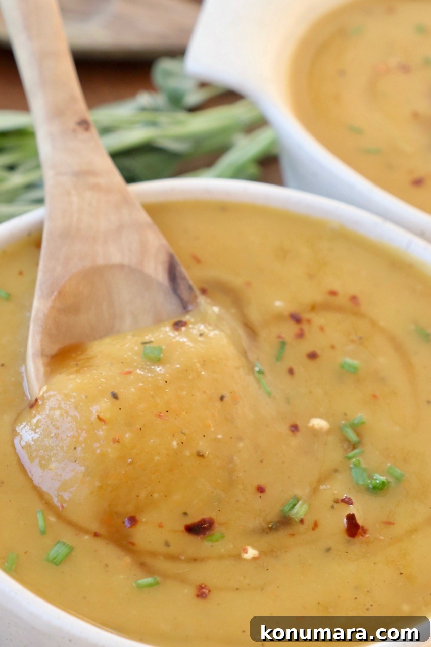 Creamy Roasted Acorn Squash Soup Recipe 9 squash soup in bowl with spoon