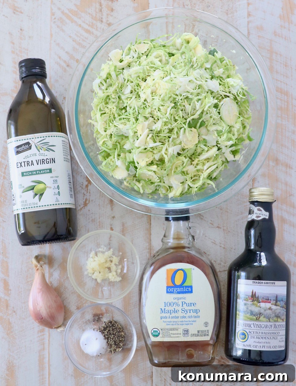 Shredded Brussels Sprouts Slaw with Lemon Vinaigrette 3 ingredients for sauteed shaved brussels sprouts on white wood board