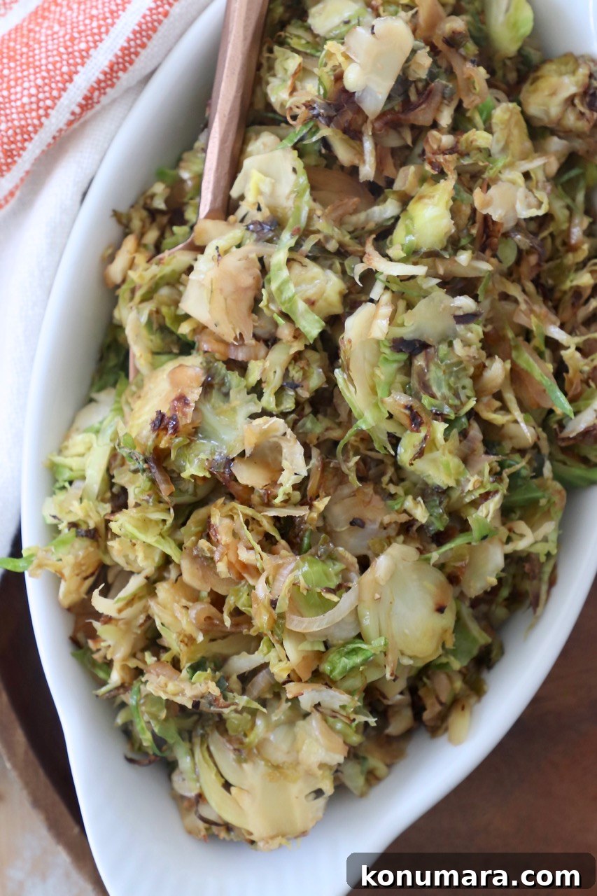 Shredded Brussels Sprouts Slaw with Lemon Vinaigrette 6 cooked shredded brussels sprouts in white serving dish