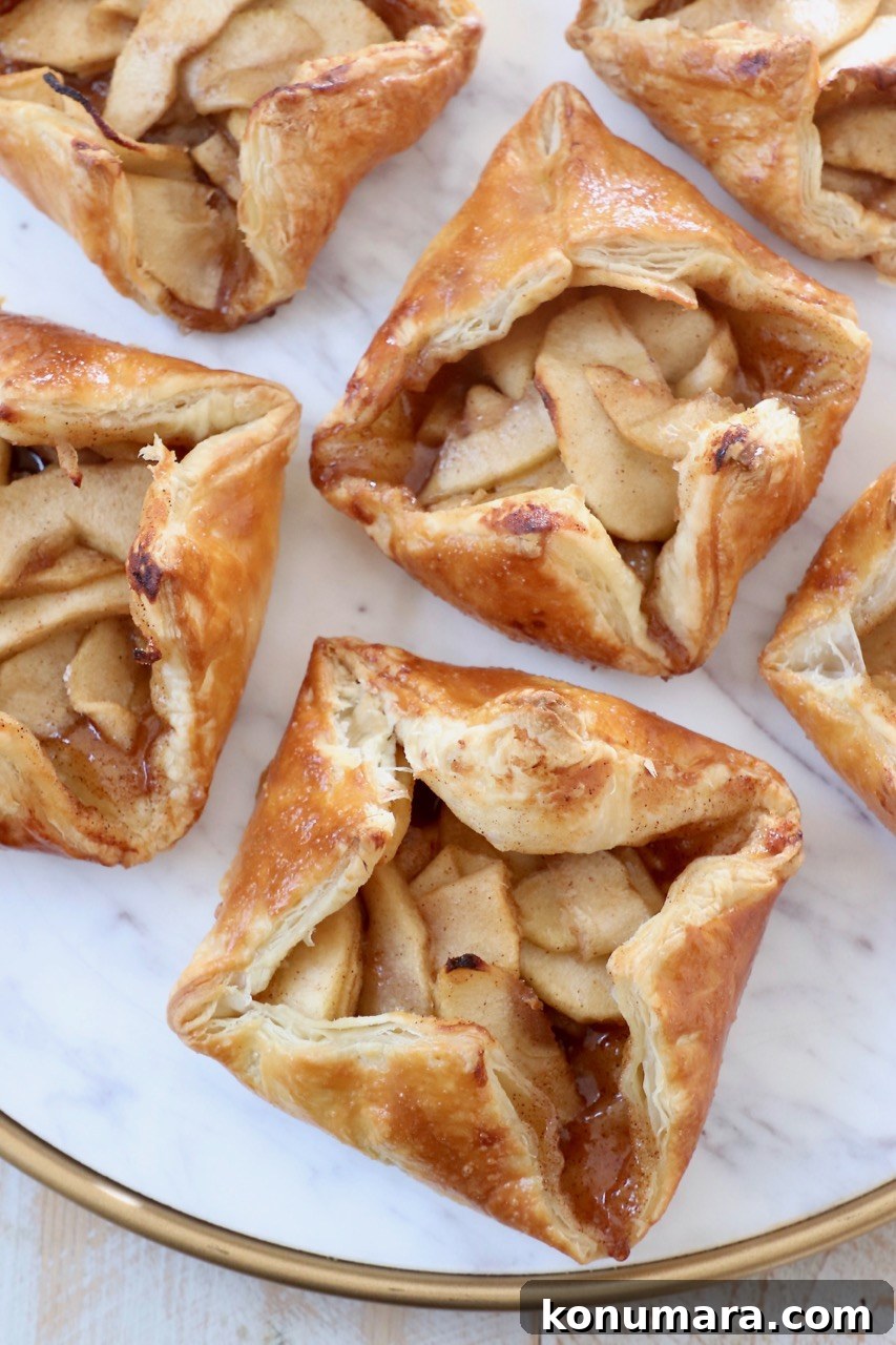 Classic Flaky Apple Danish with Cinnamon Filling 11 baked apple danishes on marble serving tray