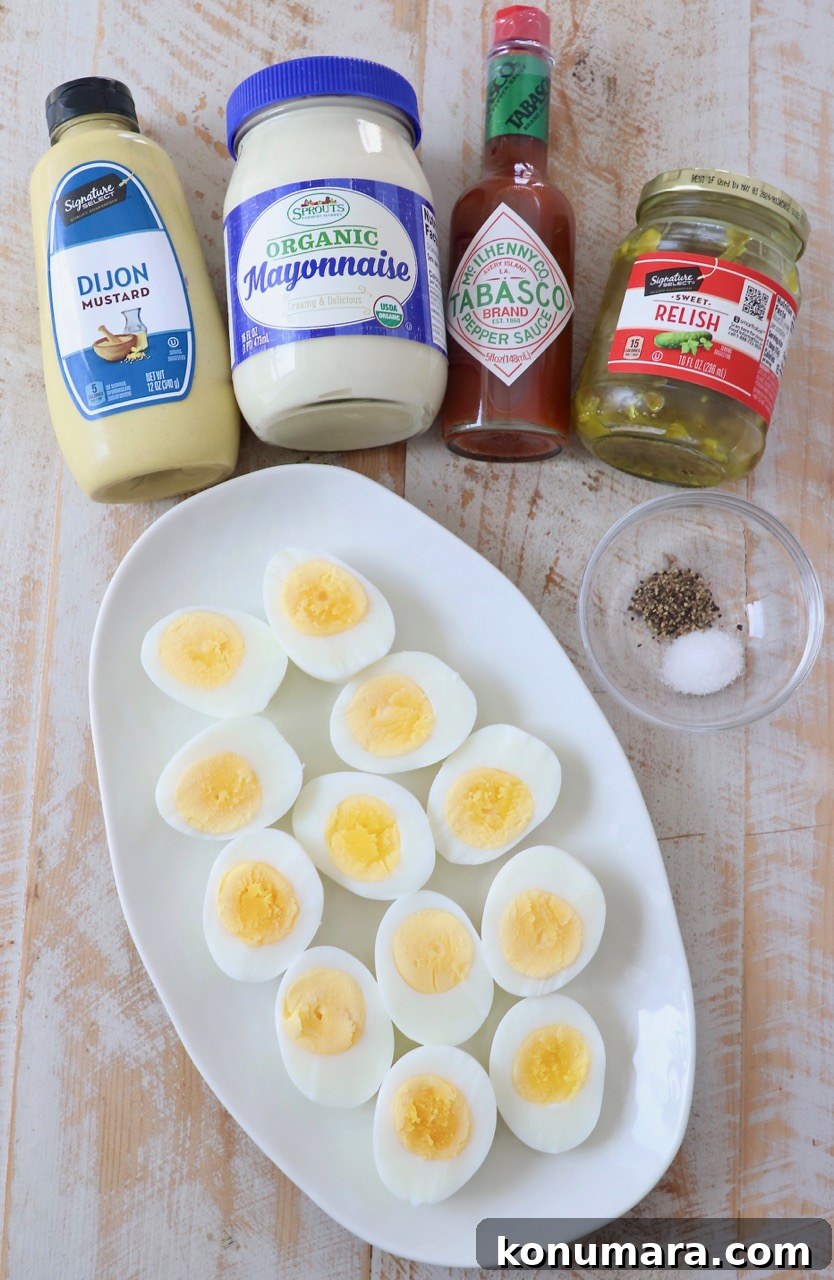 ingredients for deviled eggs on white wood board
