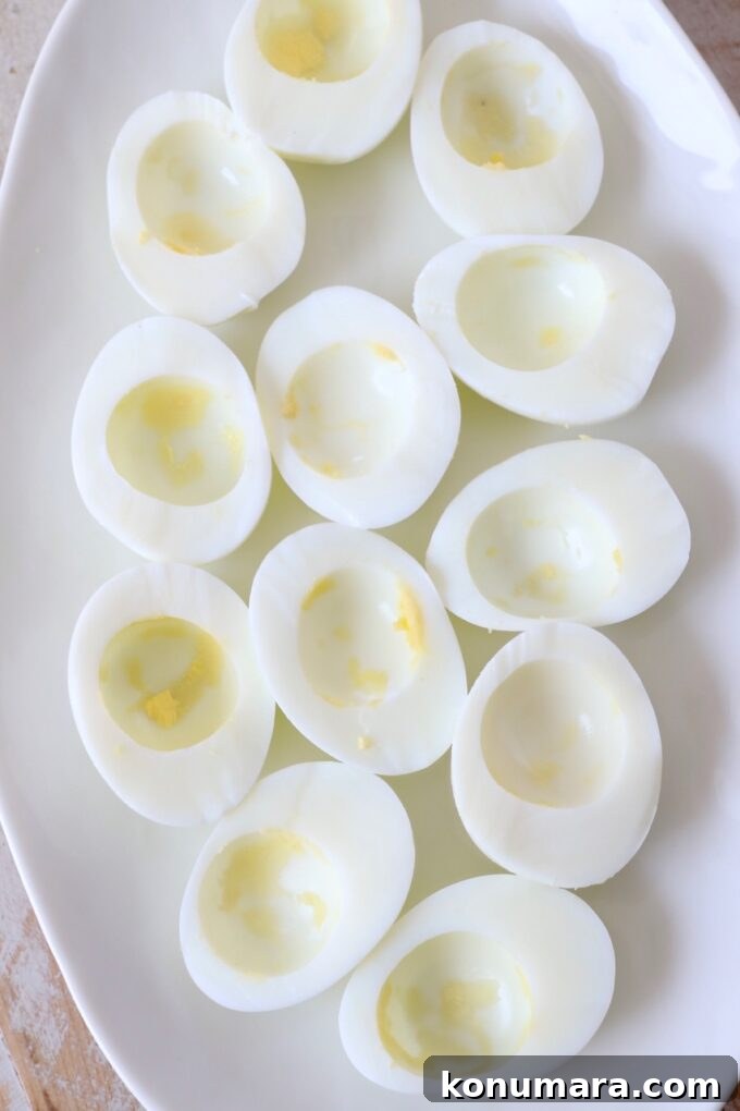 hard boiled egg whites on plate with the yolks removed
