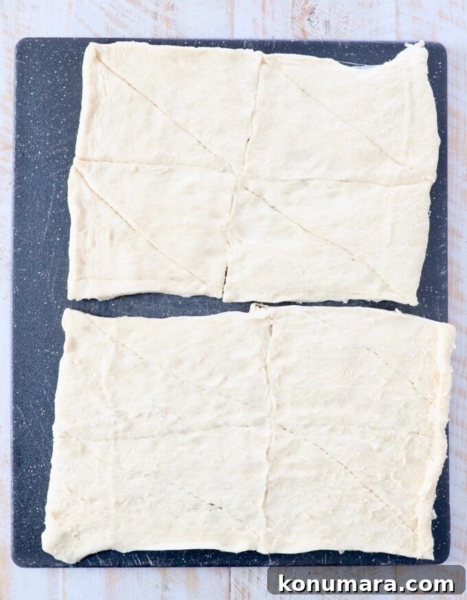 Cheesy Jalapeno Popper Crescent Rolls 6 crescent roll dough rolled out on cutting board