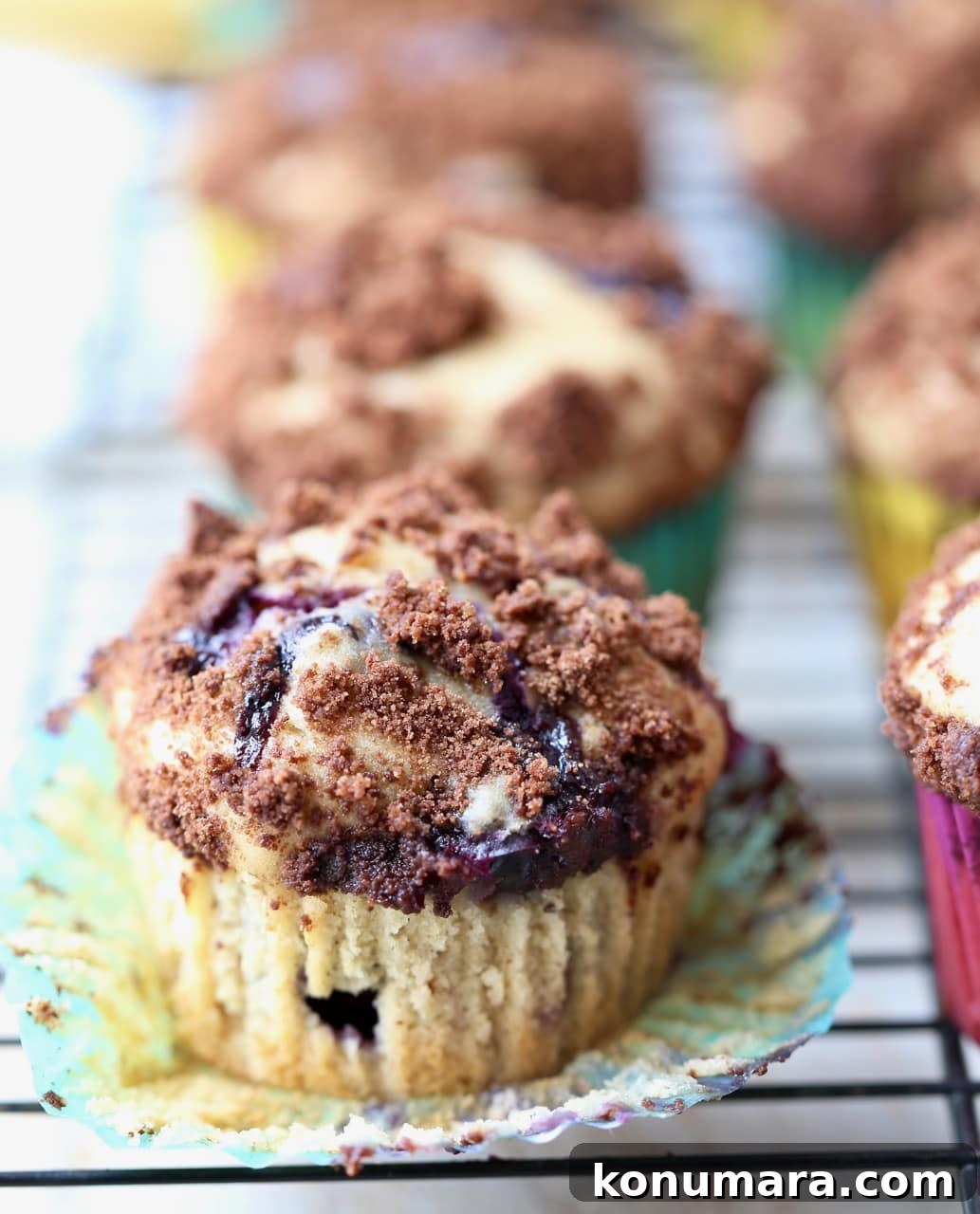Decadent Blueberry Cream Cheese Muffins with Chocolate Crumble 4 Blueberry Cream Cheese Muffins with Chocolate Crumble with Wrapper Open