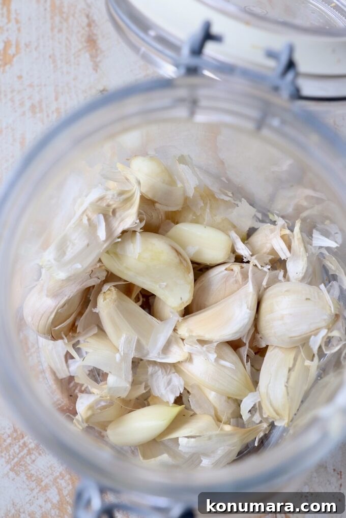 peeled garlic cloves in glass jar