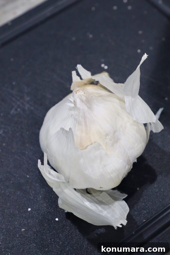 head of garlic with the outer layers peeling off