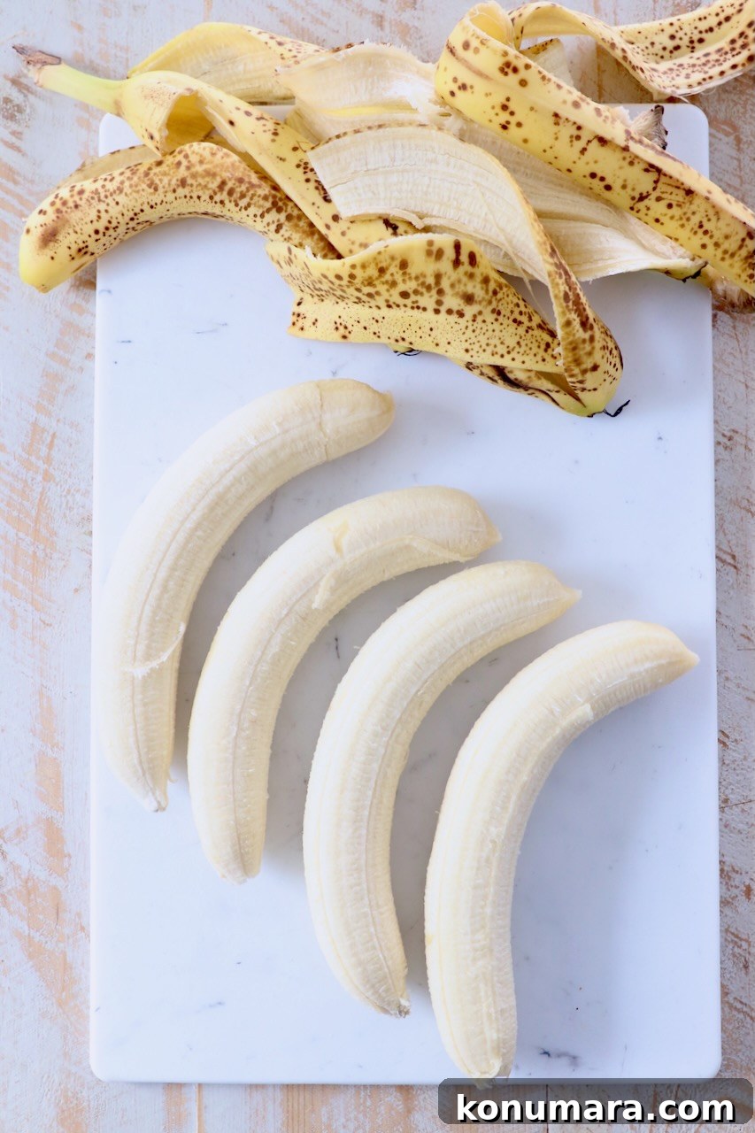 bananas with the peels removed on cutting board