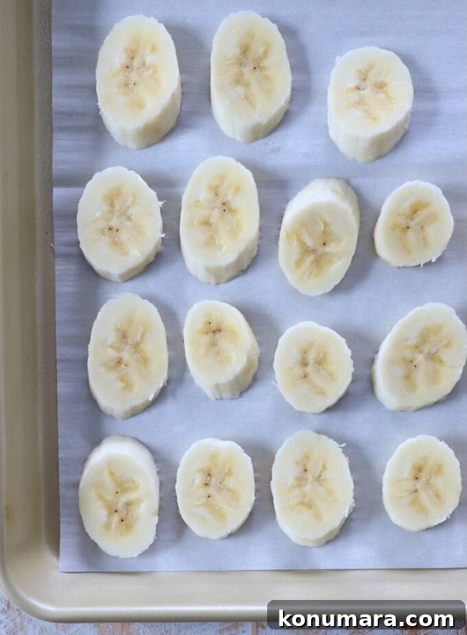 banana slices on parchment lined baking sheet