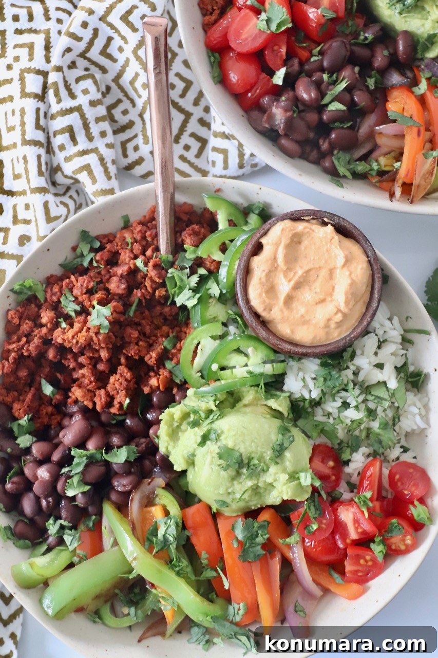 cooked vegetables, soy chorizo, beans, guacamole and rice in bowl with fork