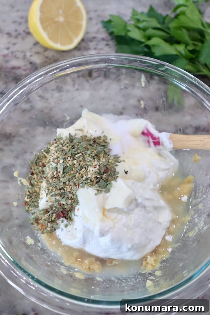 Creamy Roasted Garlic Dip Recipe 6 ingredients for garlic dip in glass bowl with spatula