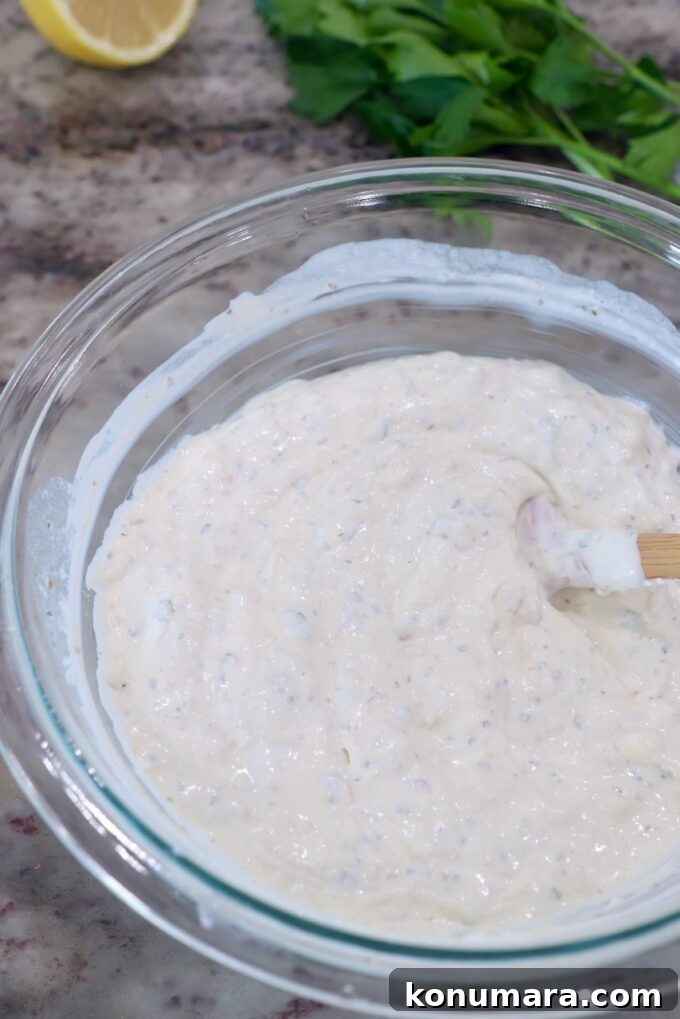 Creamy Roasted Garlic Dip Recipe 7 roasted garlic dip in glass bowl with spatula