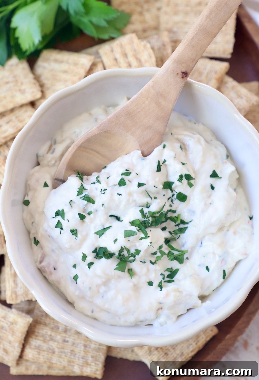 Creamy Roasted Garlic Dip Recipe 9 creamy garlic dip in bowl with spoon