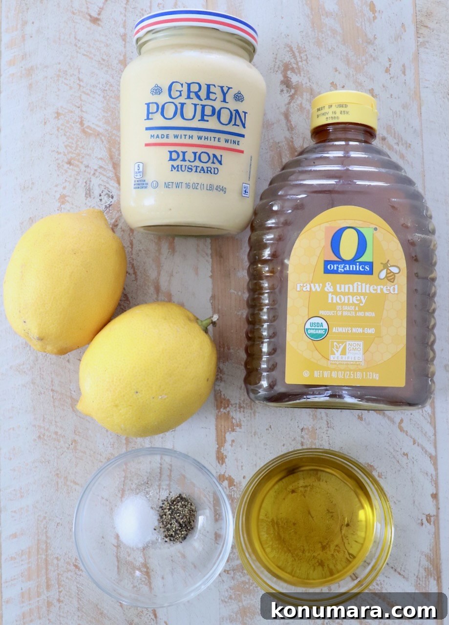 ingredients for honey mustard dressing on white wood board
