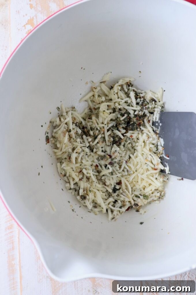 mozzarella cheese combined with butter and seasoning in mixing bowl