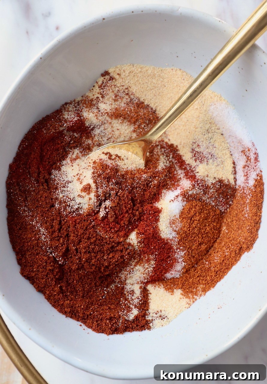Chicken Wing Seasoning Recipe for Crispy, Flavorful Wings 2 spices mixed together in bowl with gold spoon