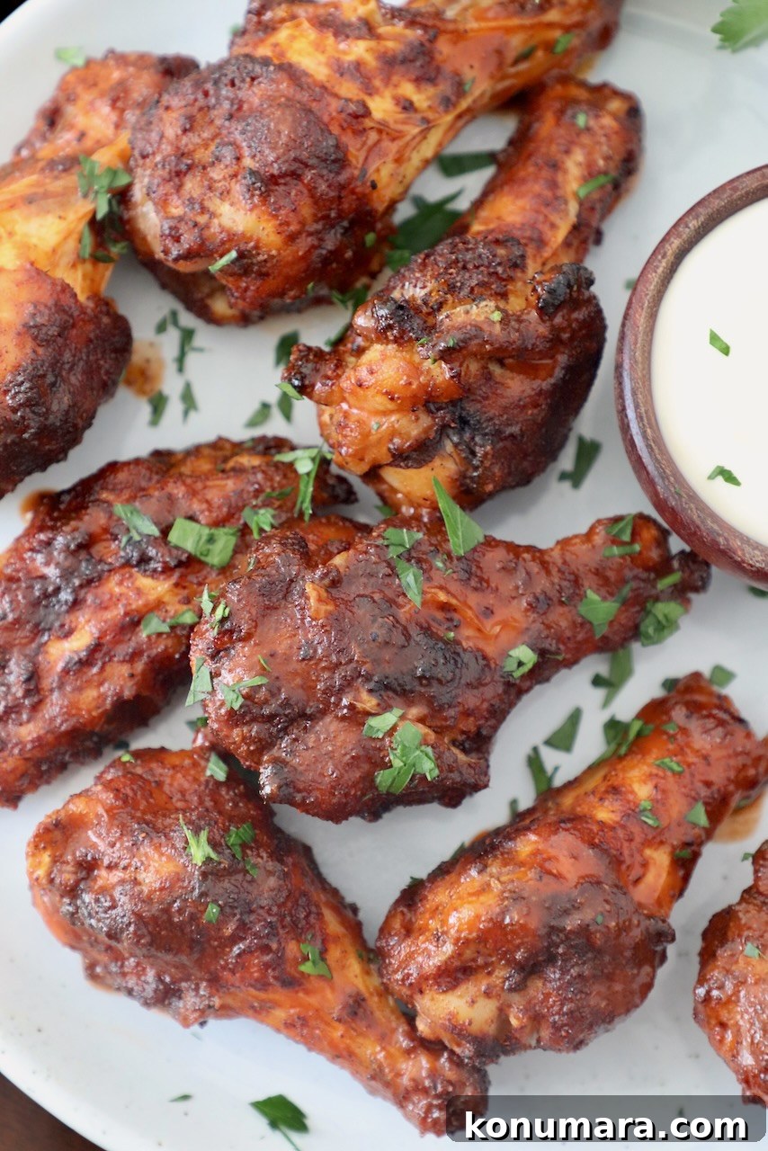 Chicken Wing Seasoning Recipe for Crispy, Flavorful Wings 6 cooked chicken wings tossed in buffalo sauce on plate