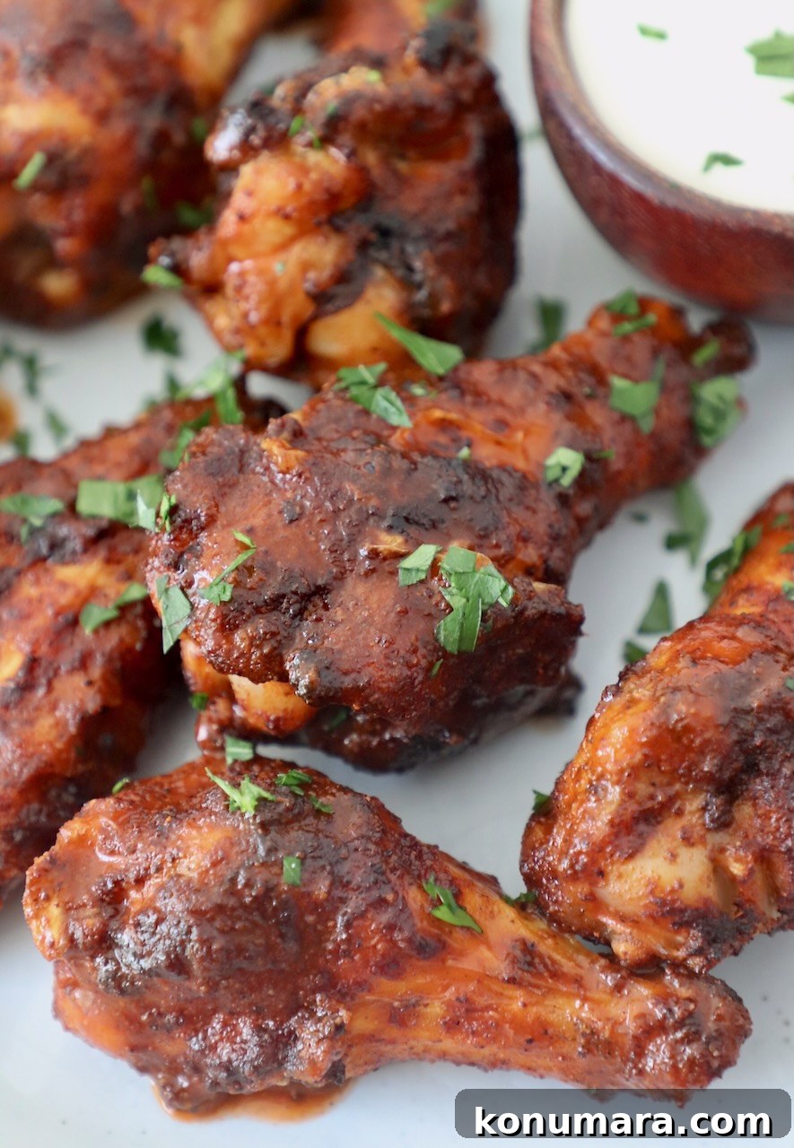 Crispy Air Fryer Chicken Wings Recipe 8 cooked chicken wings tossed with sauce on plate
