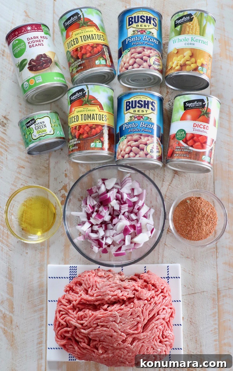 Slow Cooker Taco Soup with Ground Beef and Beans 3 ingredients for taco soup on a white wood board