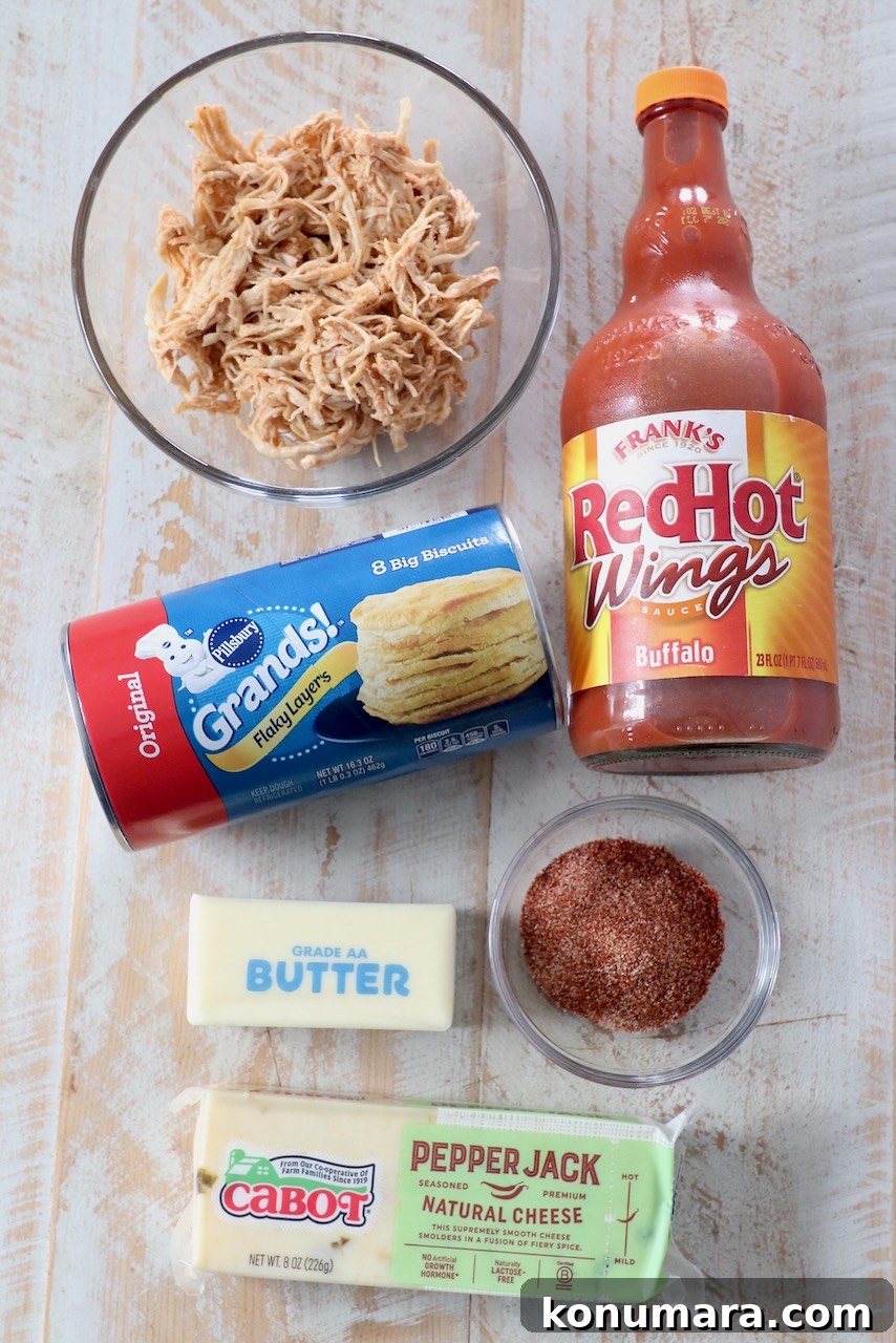 Pull-Apart Buffalo Chicken Rolls Recipe 3 ingredients for buffalo chicken rolls on wood board