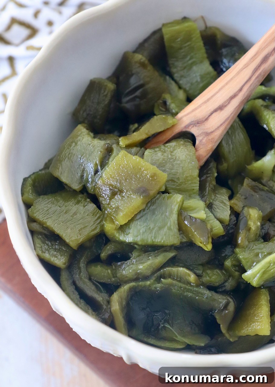 How to Roast Poblano Peppers for Salsa and Stuffing 7 diced poblano peppers in bowl with wooden fork