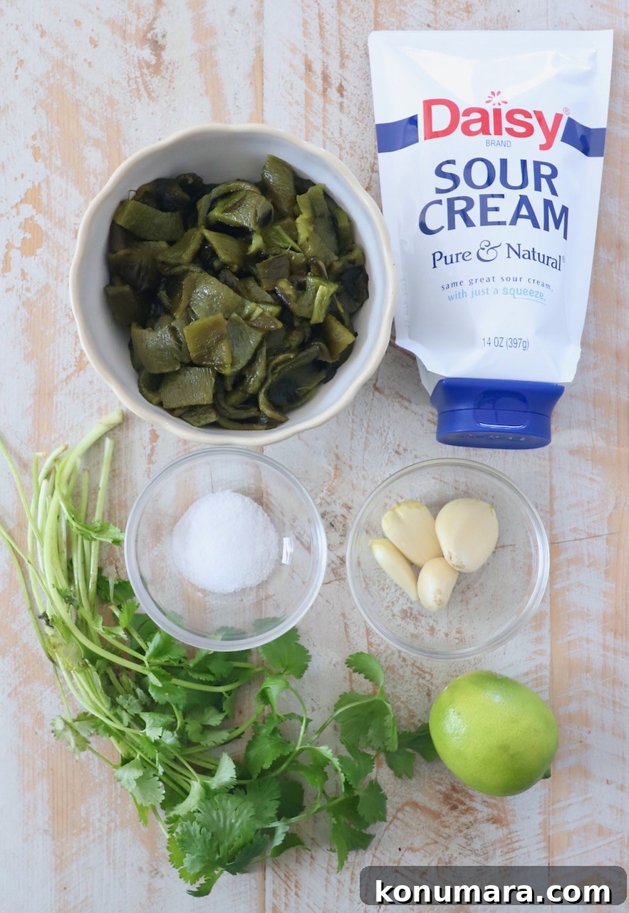 Roasted Poblano Sauce Recipe for Tacos and Enchiladas 3 ingredients for poblano sauce on white wood cutting board