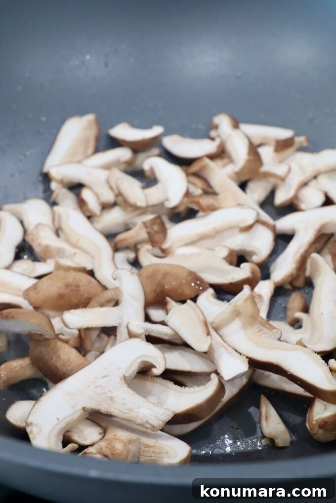 Authentic Miso Ramen Recipe 5 sliced shiitake mushrooms in wok