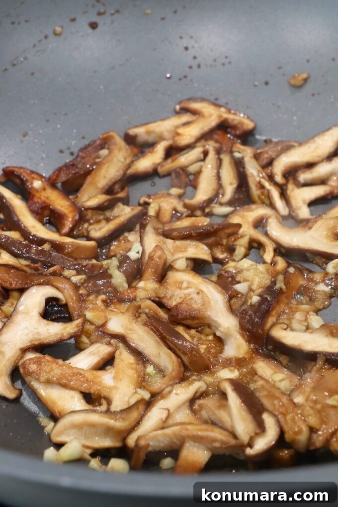 Authentic Miso Ramen Recipe 6 cooked shittake mushrooms in wok