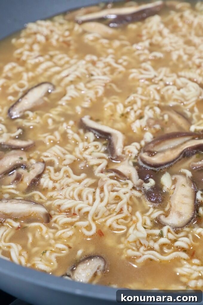 Authentic Miso Ramen Recipe 8 ramen noodles in broth with mushrooms in large wok