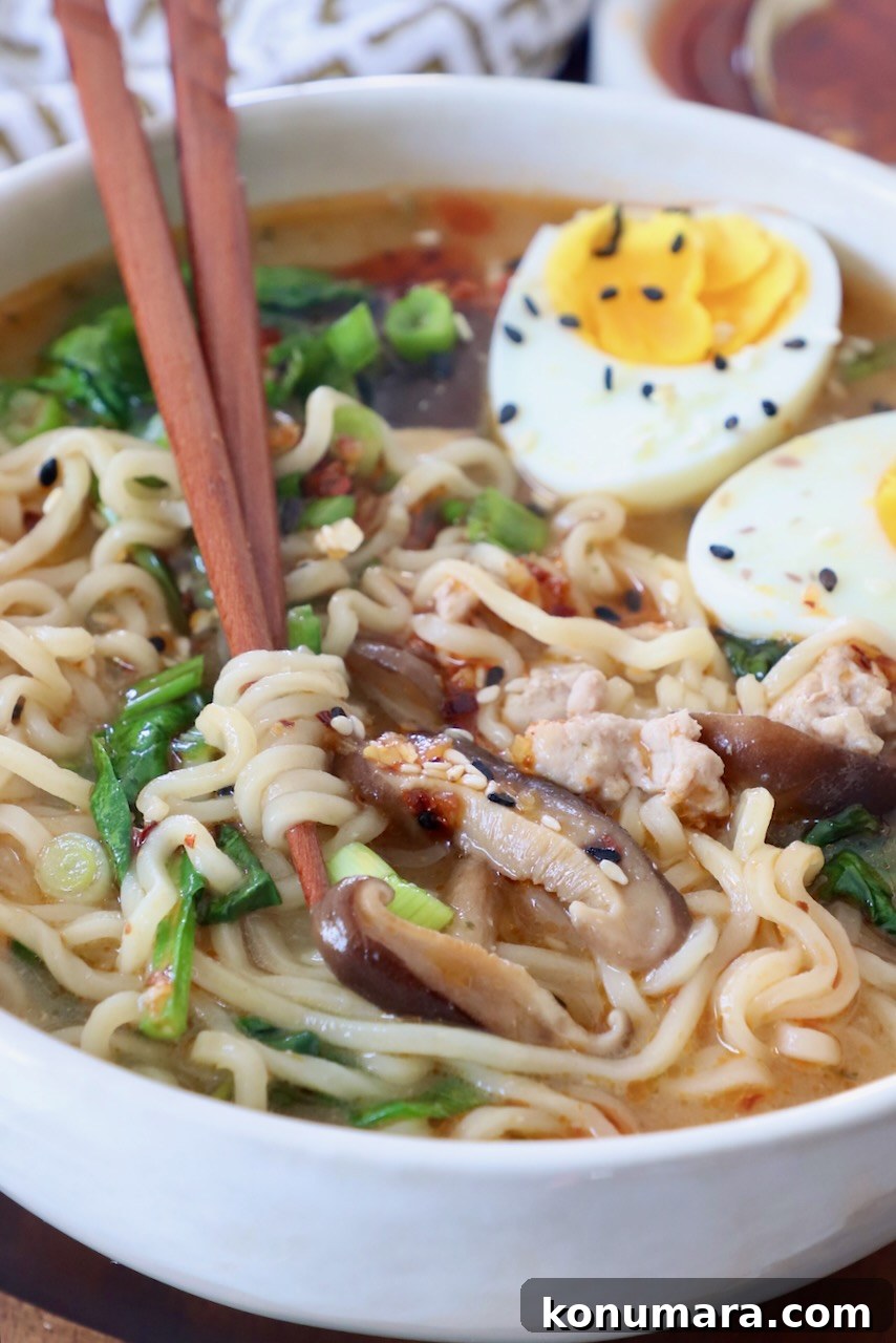 Authentic Miso Ramen Recipe 10 ramen soup in bowl with chopsticks and medium boiled eggs