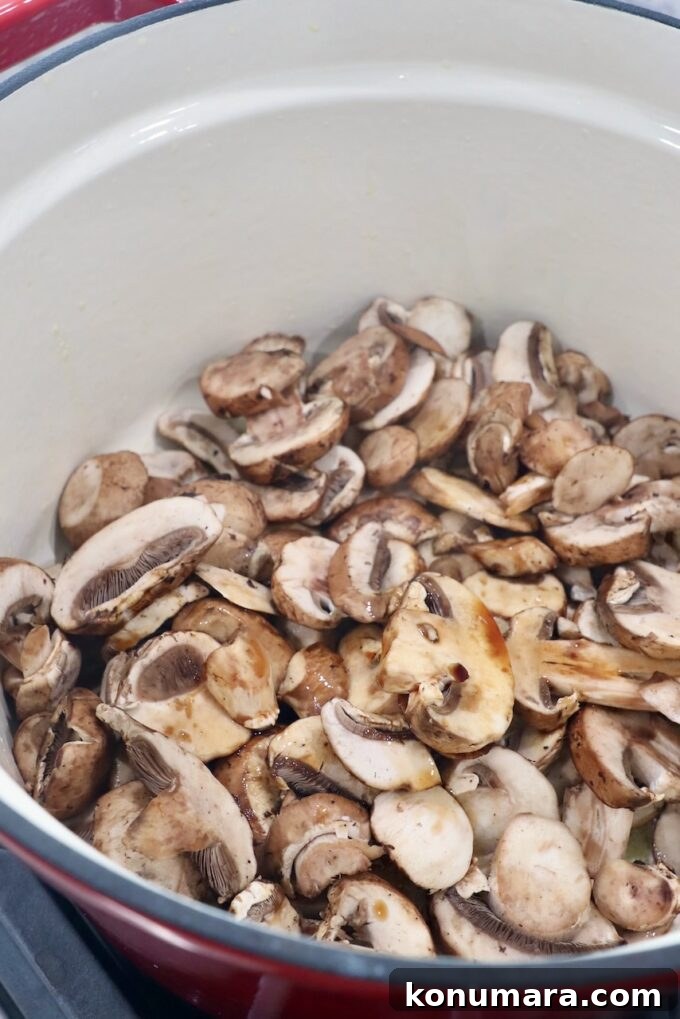 Creamy Garlic Mushroom Pasta Recipe with Parmesan 4 sliced mushrooms in pot with soy sauce