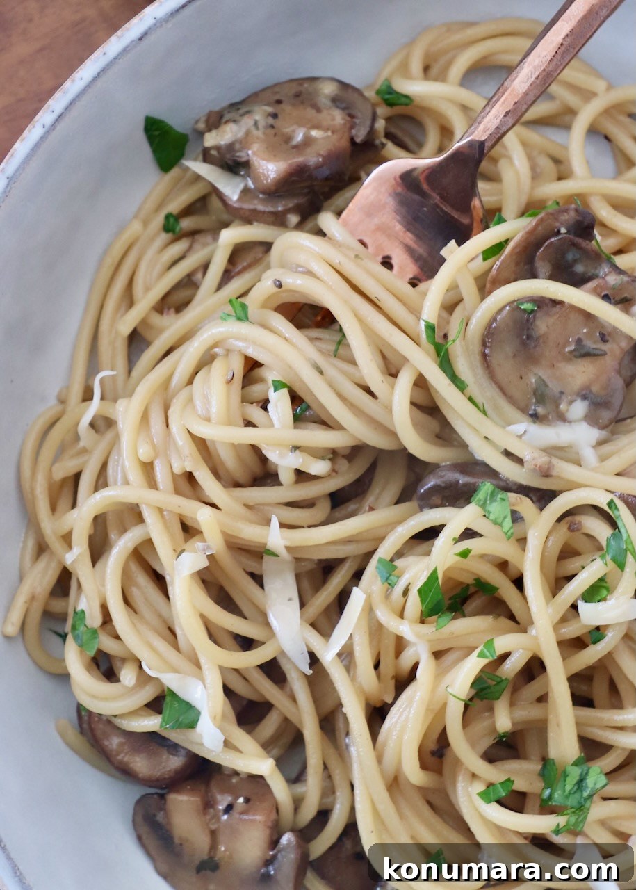 Creamy Garlic Mushroom Pasta Recipe with Parmesan 8 mushroom spaghetti in bowl with fork