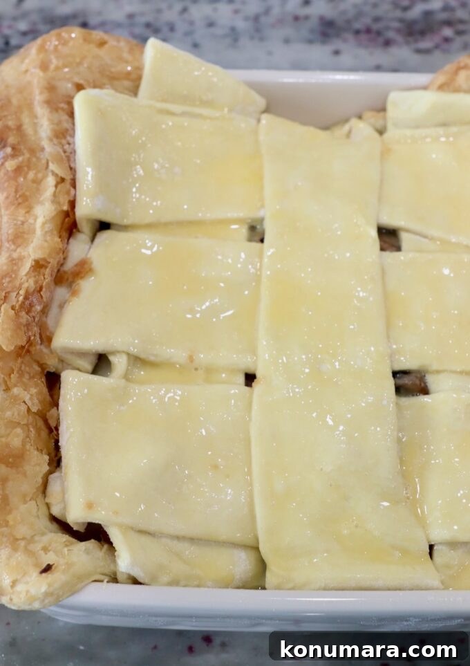puff pastry crust woven on top of pot pie in a square dish