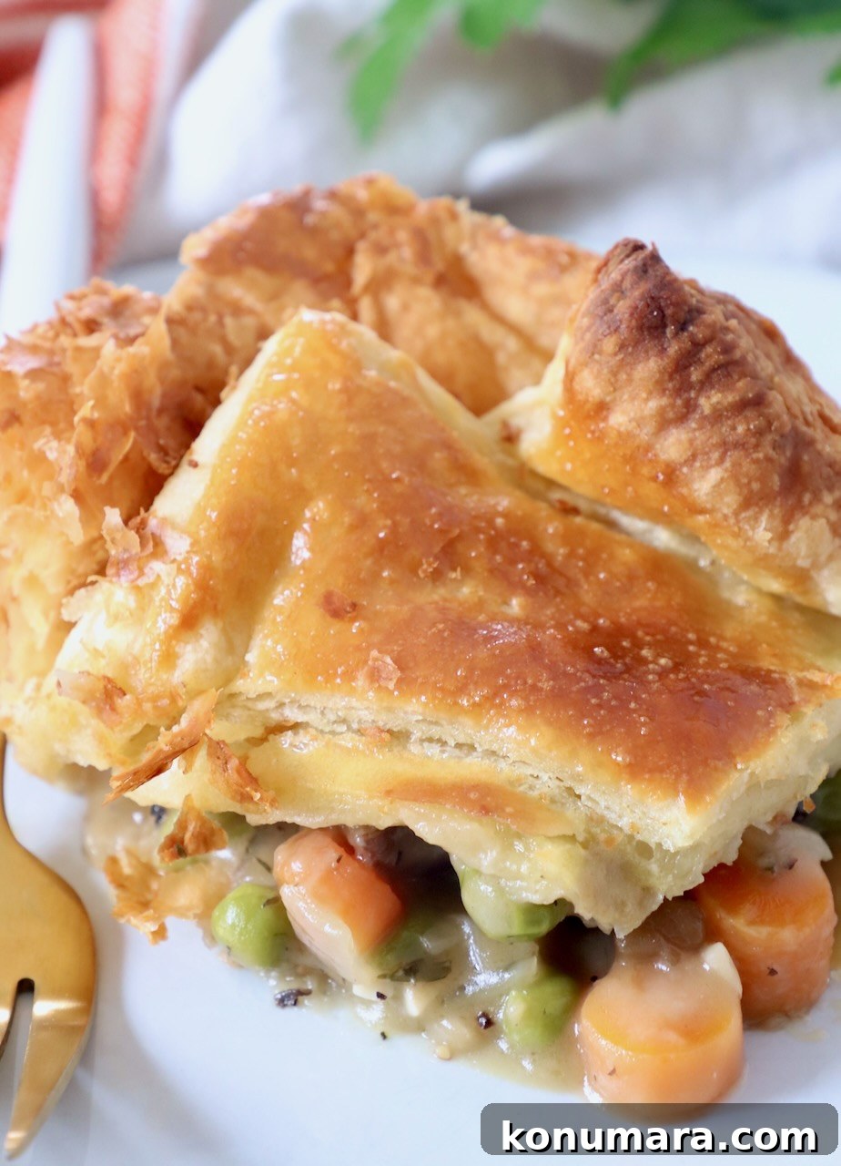 piece of vegetable pot pie on white plate with fork