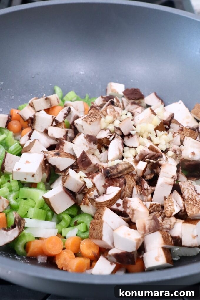 diced mushrooms in pan with onions, carrots and celery