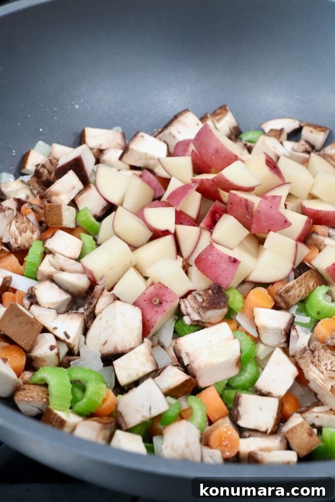 diced potatoes in pan with other diced vegetables