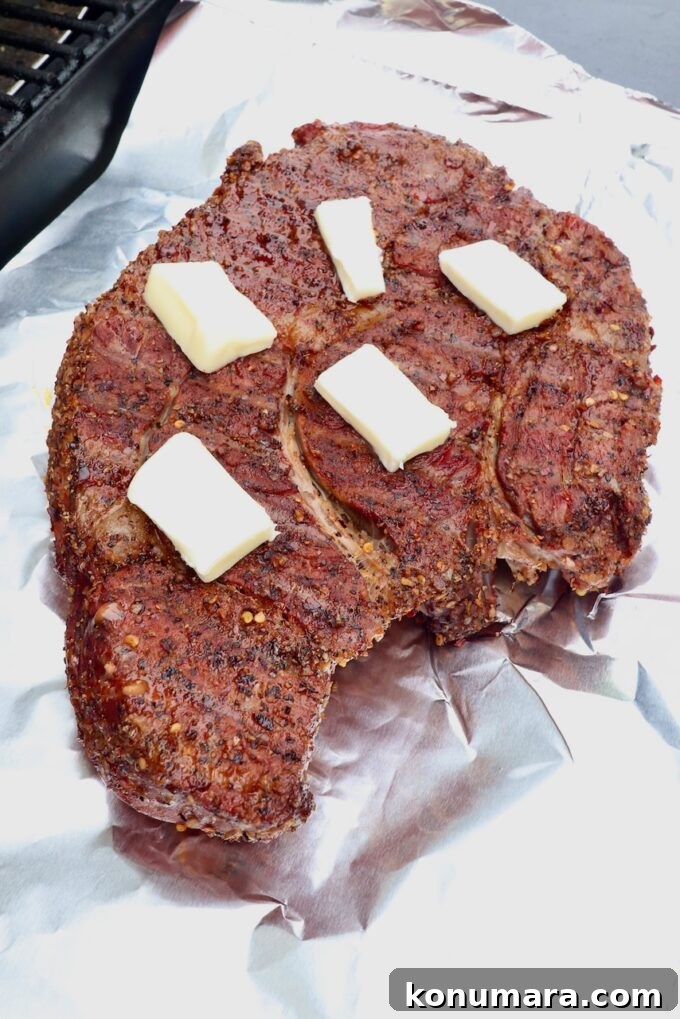 How to Smoke a Chuck Roast for Tender, Juicy Results 6 seasoned smoked chuck roast topped with pats of butter on top of a piece of foil