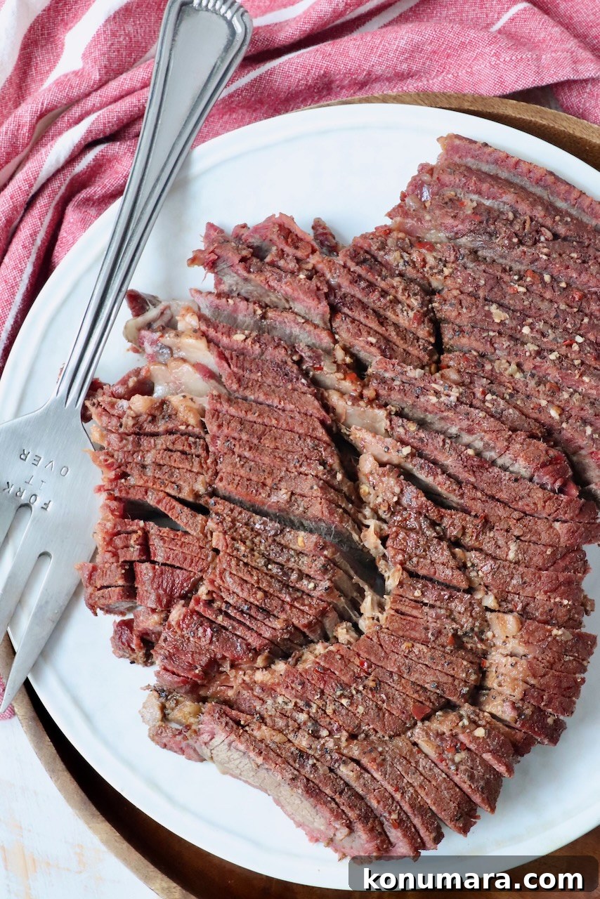 How to Smoke a Chuck Roast for Tender, Juicy Results 9 sliced chuck roast on plate with serving fork