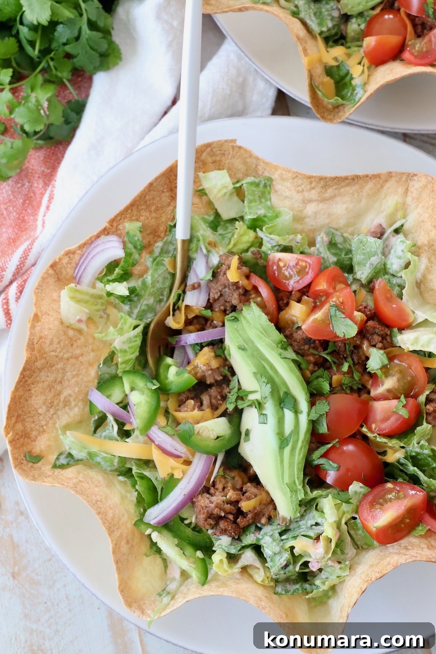 taco salad in tortilla shell with fork
