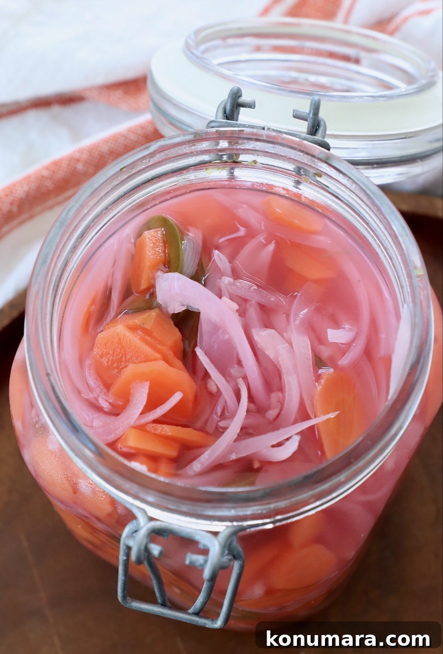 pickled vegetables in large glass jar with the lid open