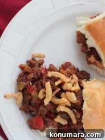 Crowd-Pleasing Slow Cooker Sloppy Joe Sliders Recipe 2 Sloppy Joe sliders on Hawaiian rolls topped with crispy onions