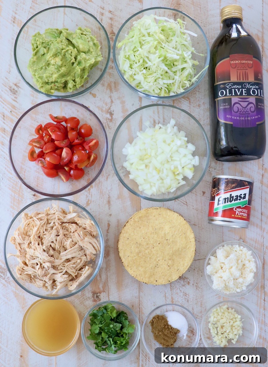 ingredients for chicken tostadas on white wood cutting board
