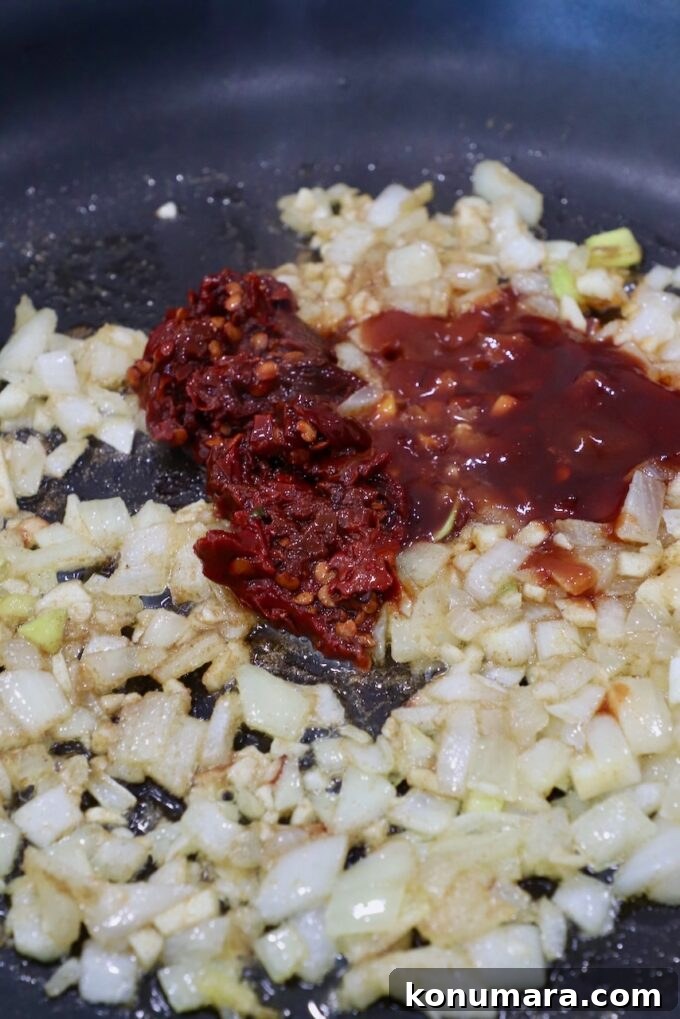 chipotle chilies in skillet with diced onions