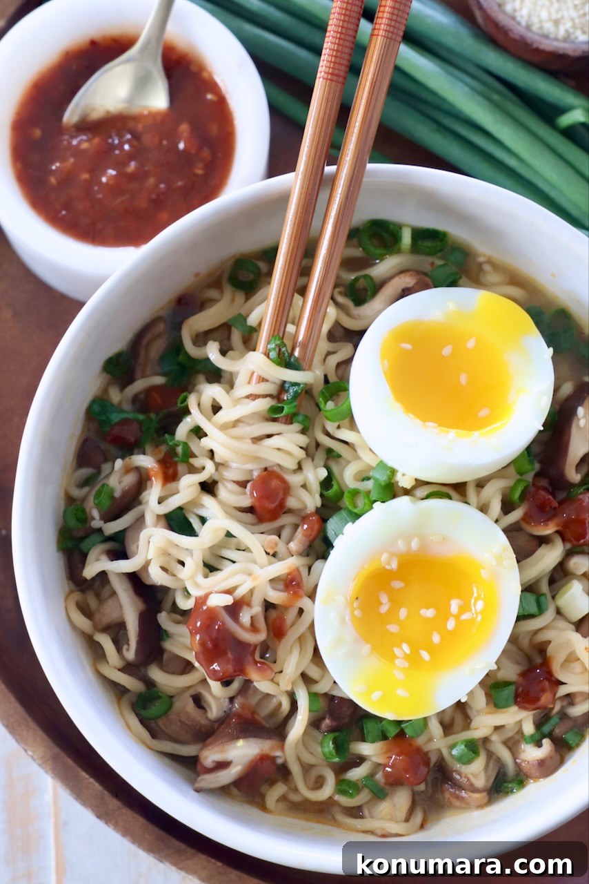 Vegetarian Ramen Recipe: Miso Umami Broth with Vegetables 2 ramen noodle soup in bowl with chopsticks, topped with a soft boiled egg, cut in half