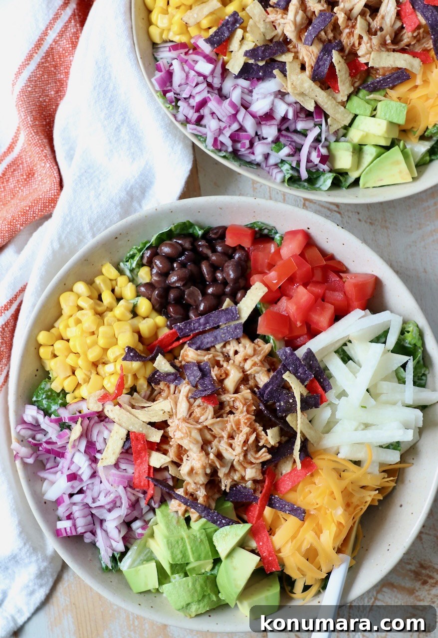 bbq chicken salad in two bowls with forks